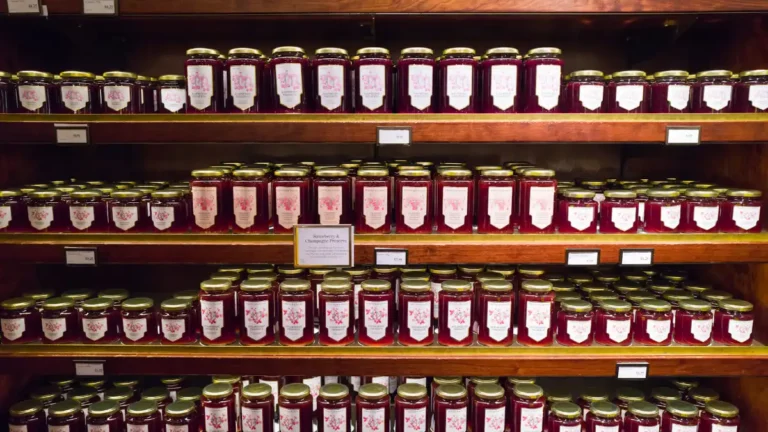 Shelves lined with rows of jam jars in a shop