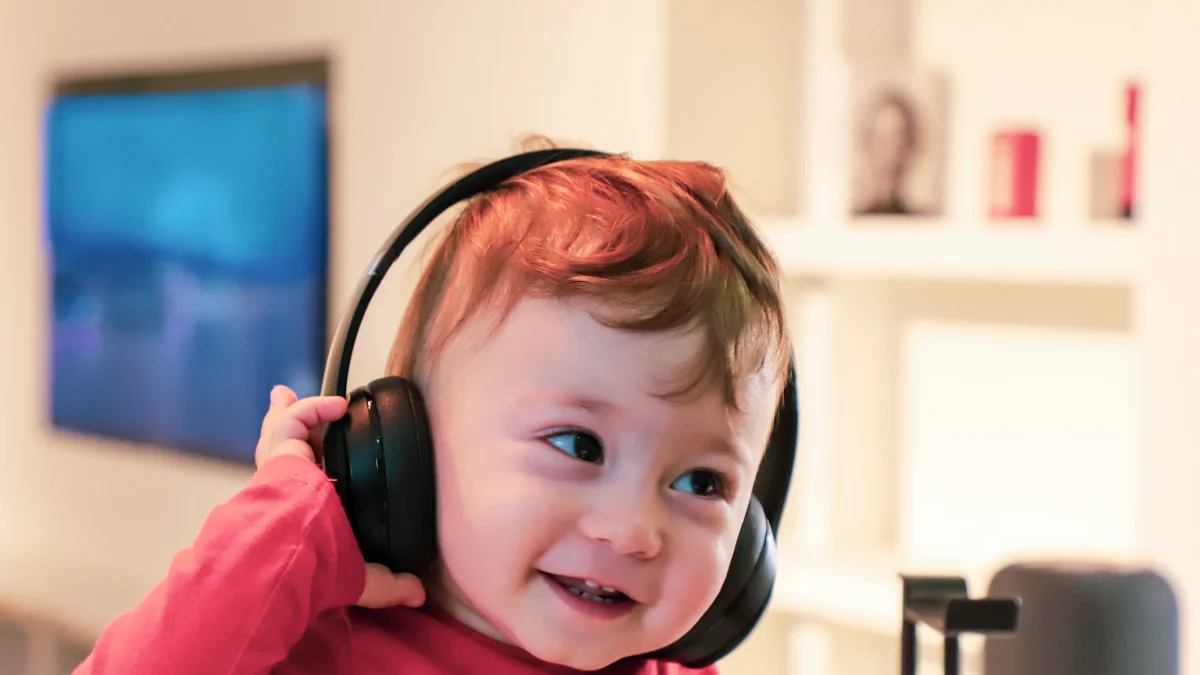 A baby wearing large headphones