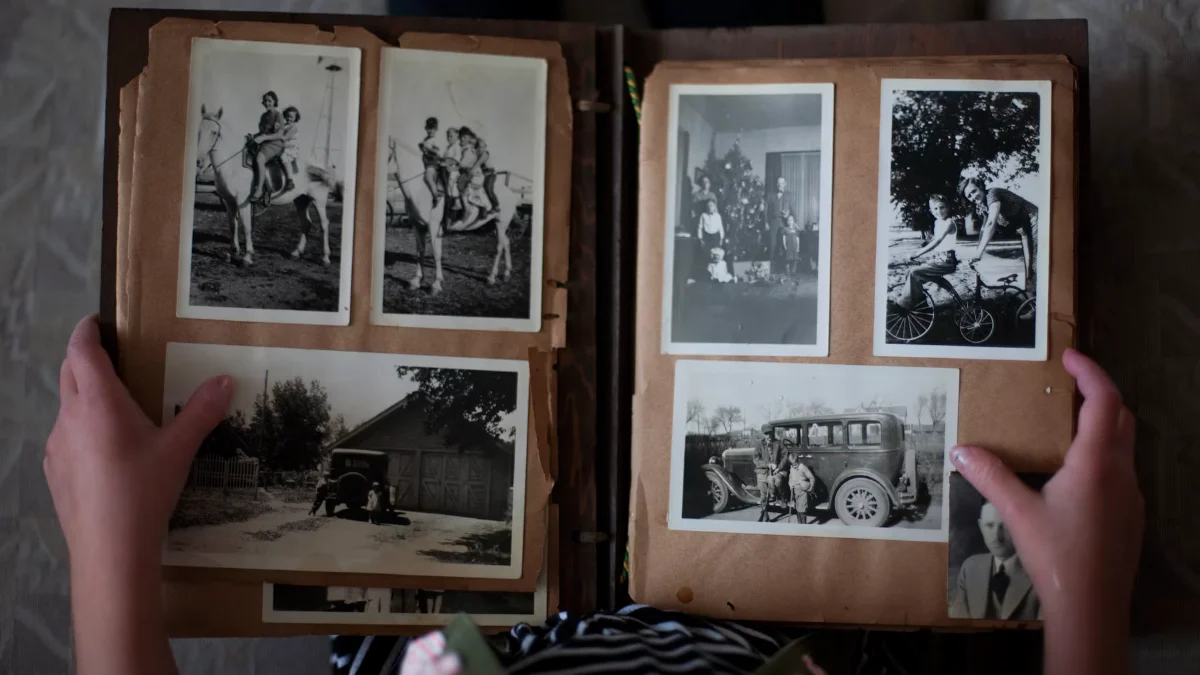 Hands turning the pages of an old photo album