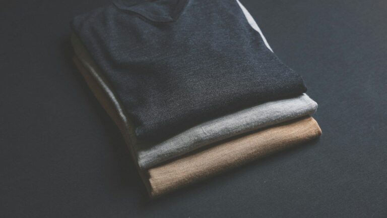 Three plain V-neck T-shirts in black, grey and brown
